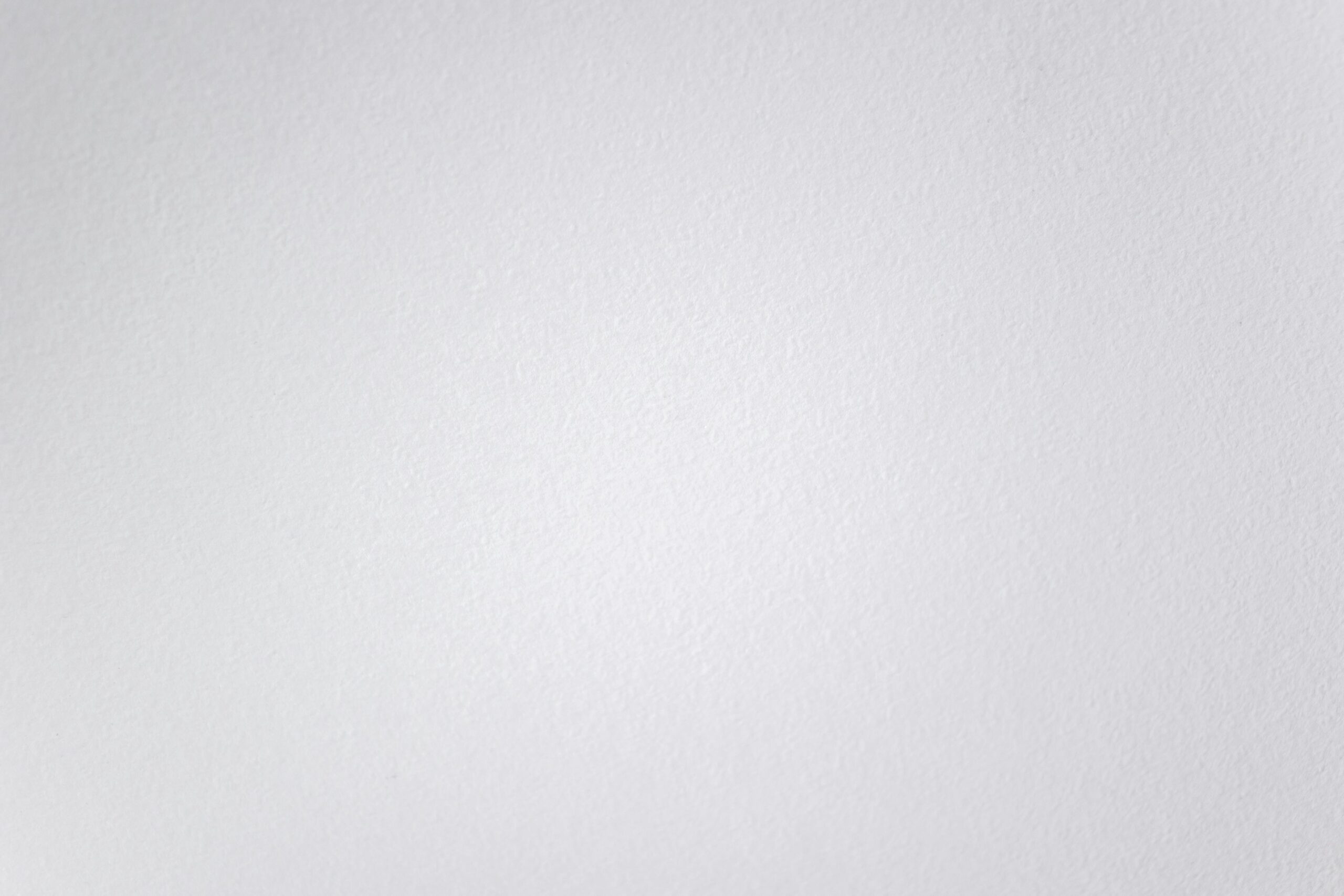 Subtle texture of a clean white wall, perfect for minimal designs.